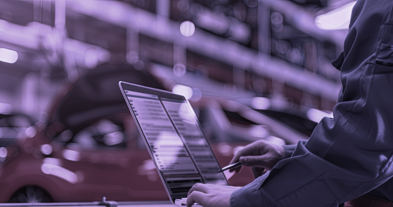 Person at workshop checking for Information on screen of Laptop.